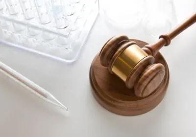 a gavel with a pipet and wellplate